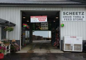 Drive-thru feed store entrance with signage.